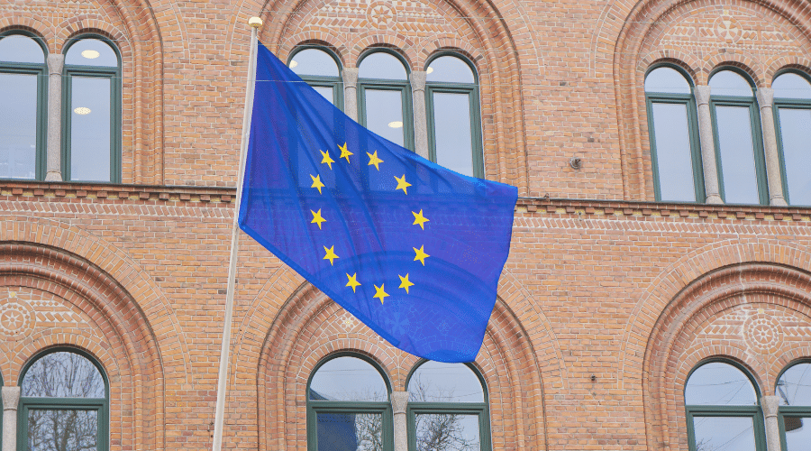 EU- flag in front of brick building.