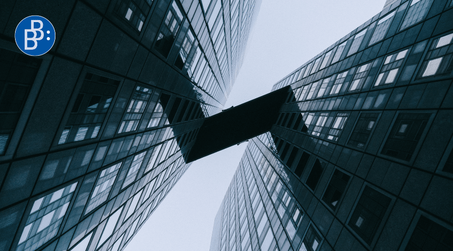 View from the ground up to a bridge between buildings.